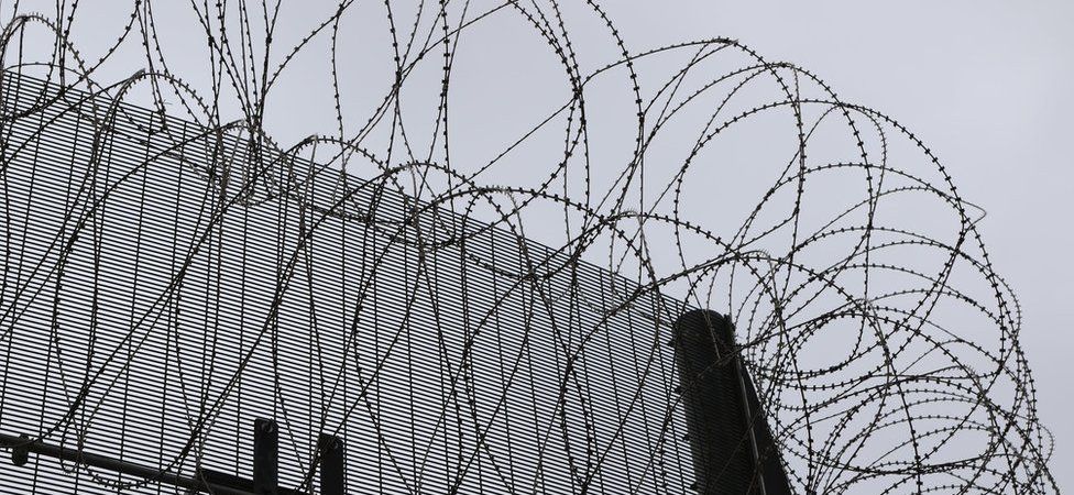 Barbed wire on top of a prison fence