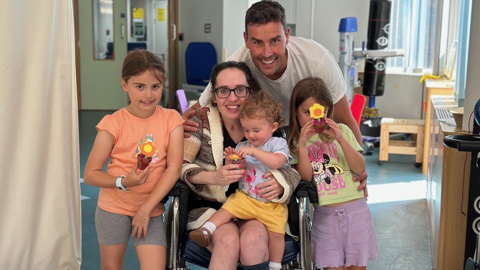Daniel and Rebecca Sharp in hospital with their three children