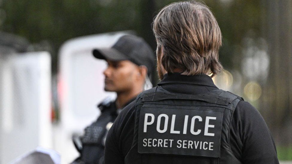 A Secret Service agent is seen at a protest in Washington DC