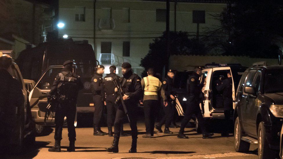 Spanish police patrol the streets of Albalate del Arzobispo in Teruel province after three people, including two police officers, were killed.