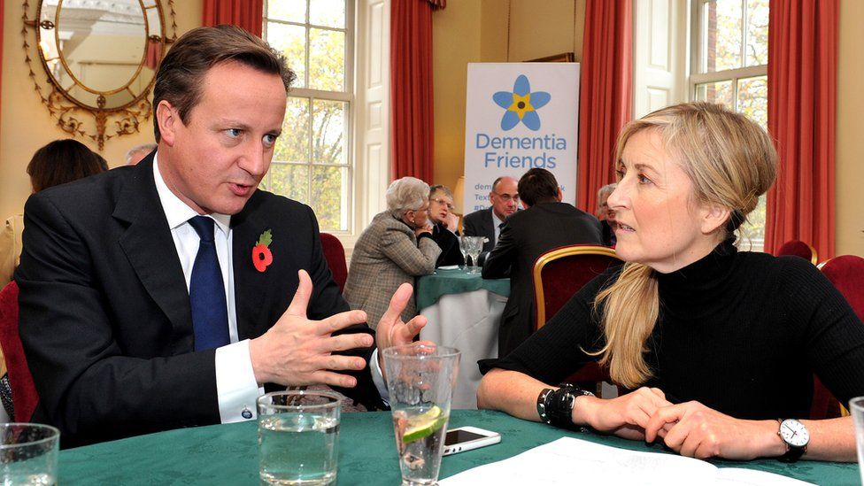 Prime Minister David Cameron listens to TV presenter Fiona Phillips during a reception for elderly sufferers of Dementia, launching an ambitious plan to create masses of "dementia friends", at Downing Street on November 8, 2012