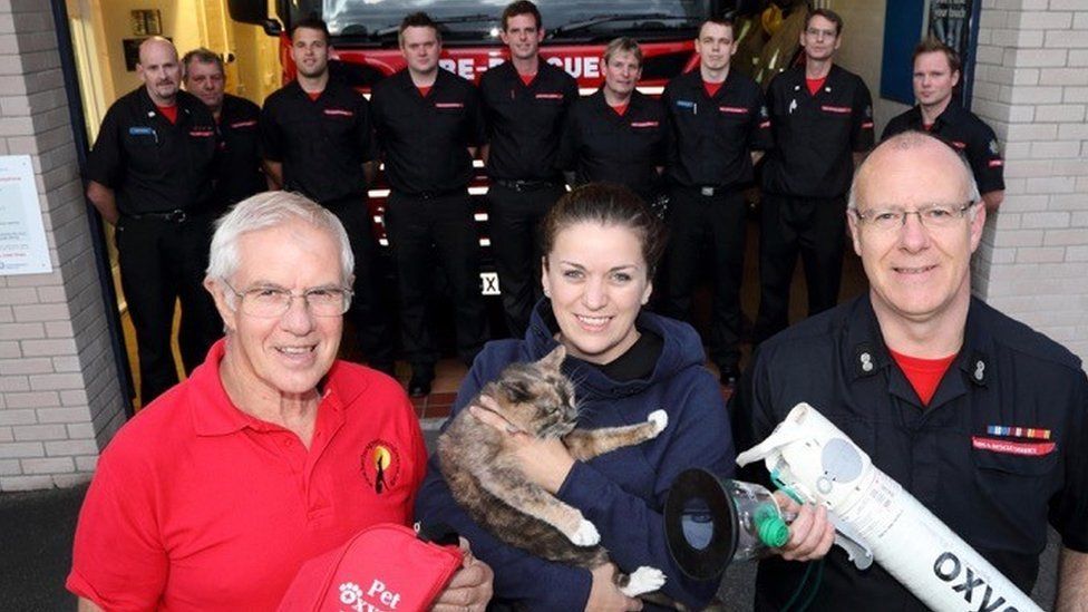 Harriet and her owner with firefighters