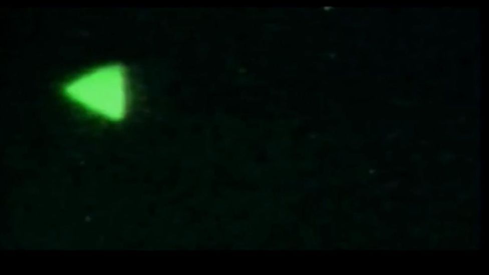 An image of a UAP shown to US lawmakers, which looks like a green triangle against a black sky