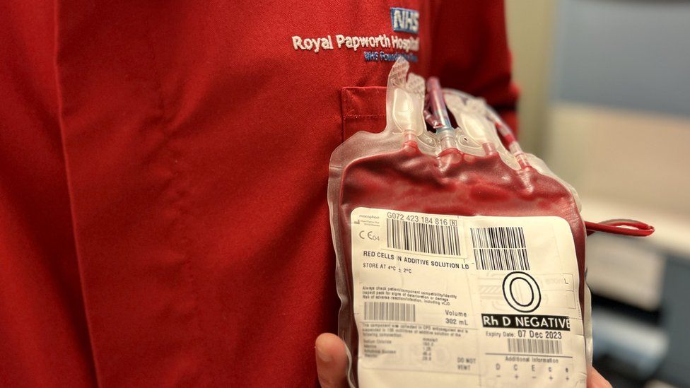 Man in blood lab holding one unit of blood at Royal Papworth Hospital