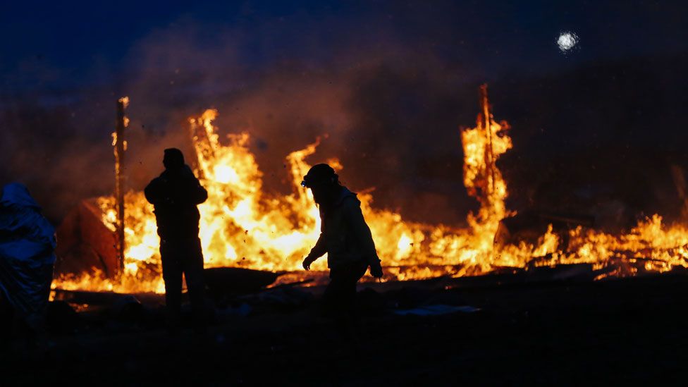 Protesters set fire to encampment