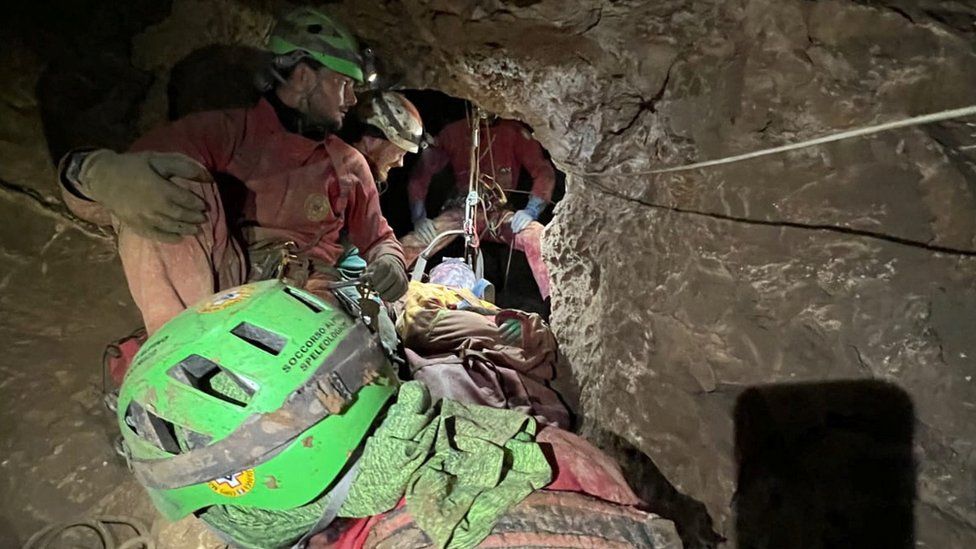 Italian Alpine rescuers (CNSAS) carry Mark Dickey on stretcher