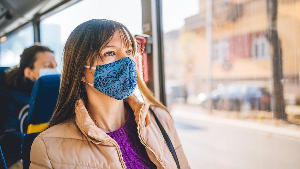 Passenger wearing mask on bus