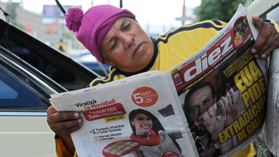 Man reading newspaper in Honduras