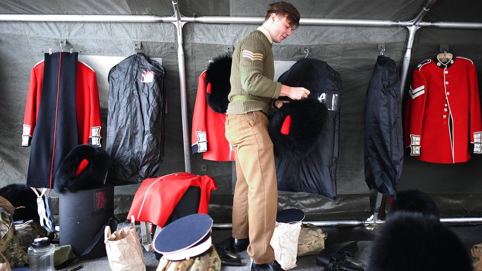 A member of the Coldstream Guards preparing his uniform