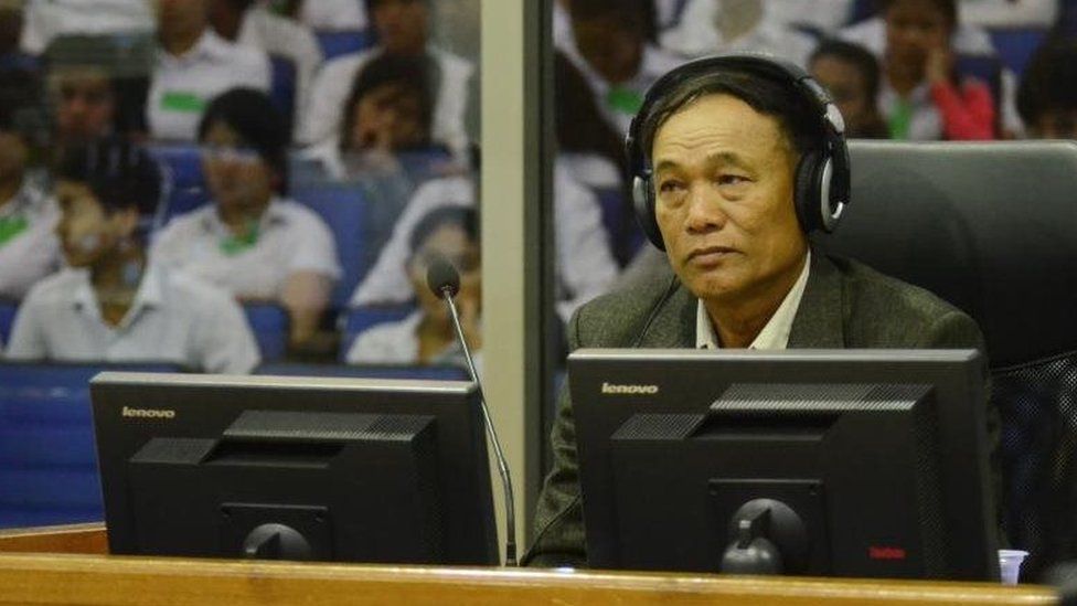 Soy Sen wearing headphones in the trial chamber