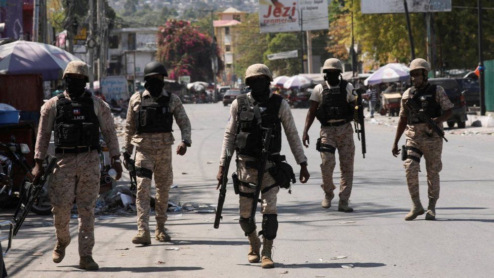 Police patrol a street in Port-au-Prince, Haiti