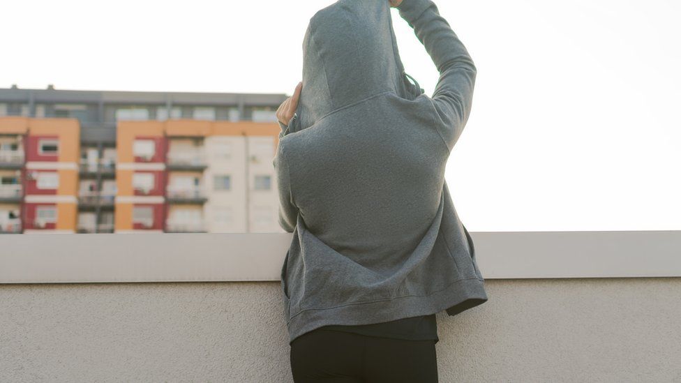A girl standing in a hoodie