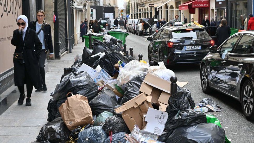 Garbage cans overflowing with trash on the streets as collectors continue their strike in Paris, France on March 17, 2023