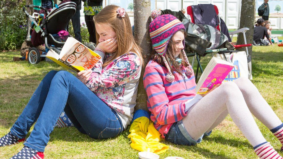 Young girls reading at Hay Festival