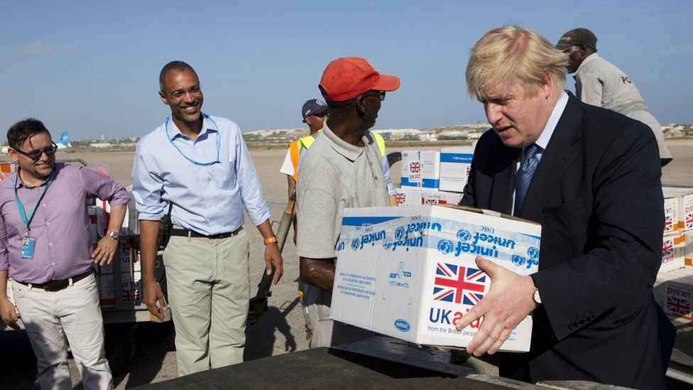 Boris Johnson helping to load supplies onto a cargo plane at Aden Adde International Airport, in Mogadishu, Somalia