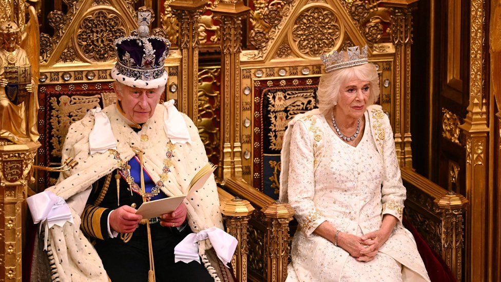 King Charles III delivers a speech beside Queen Camilla during the State Opening of Parliament in the House of Lords at the Palace of Westminster in London