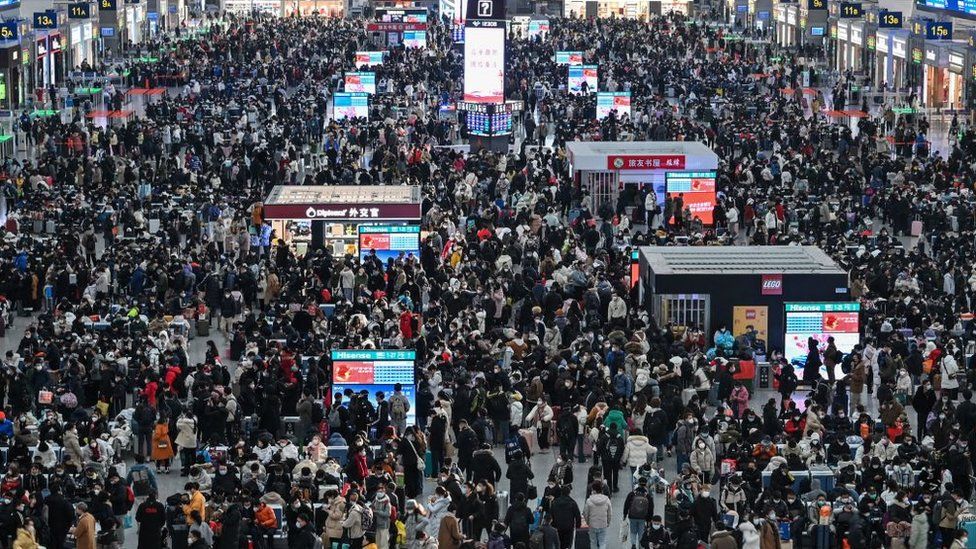 Passengers wait for their train at Hongqiao railway station in Shanghai on January 20, 2023