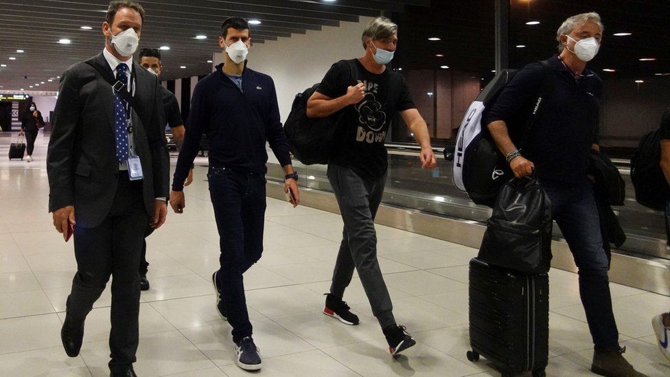 Novak Djokovic walks in Melbourne Airport before boarding a flight