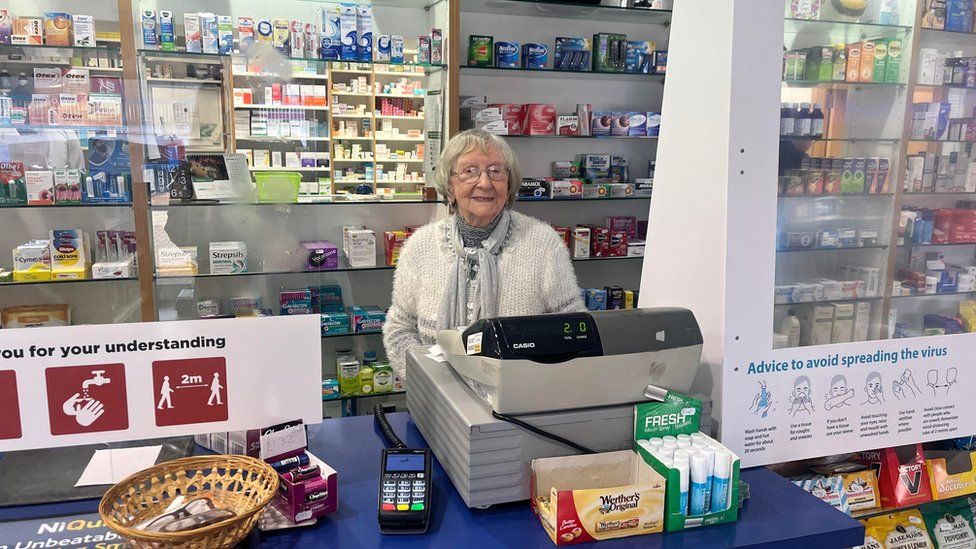 Betty Pritchard behind the till