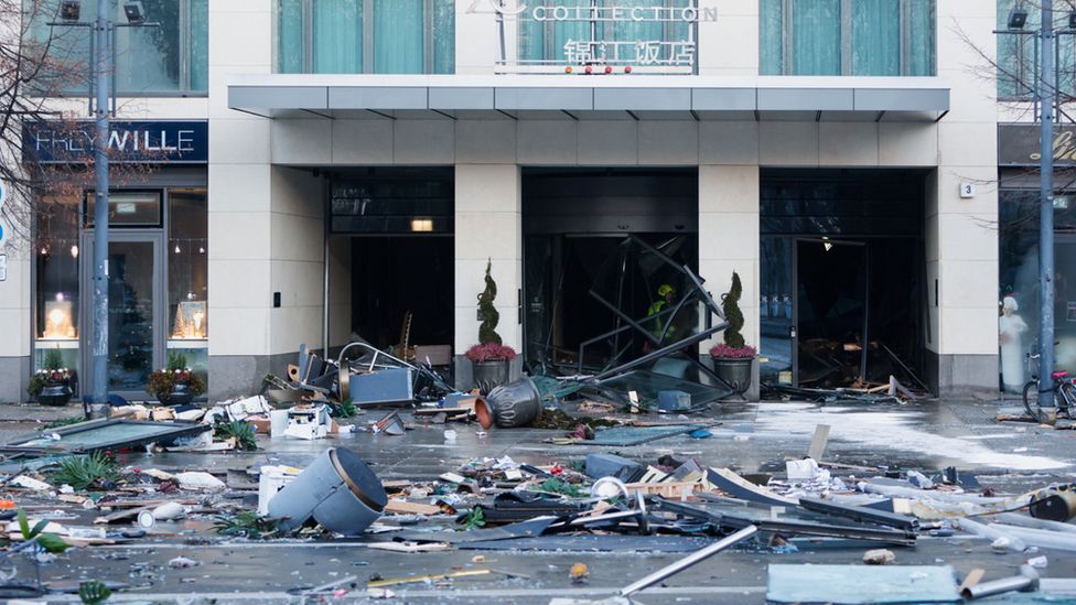 Image of the front of the Radisson Blu hotel showing a large amount of debris which has been washed into the street