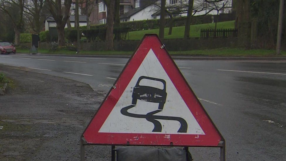 Slippery road sign at the scene of the crash in Buxton Road West, Disley