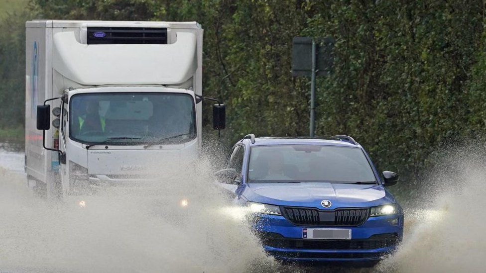 A car drives through flood water near Folkestone, Kent, during Storm Ciaran in November 2023