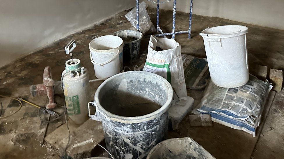Large buckets of plaster and paint