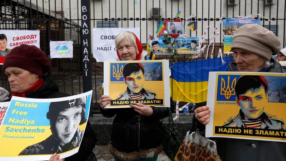 Women holds posters depicting Ukrainian pilot Nadiya Savchenko outside the Russian Embassy in Kiev, Ukraine, Tuesday, 22 March 2016