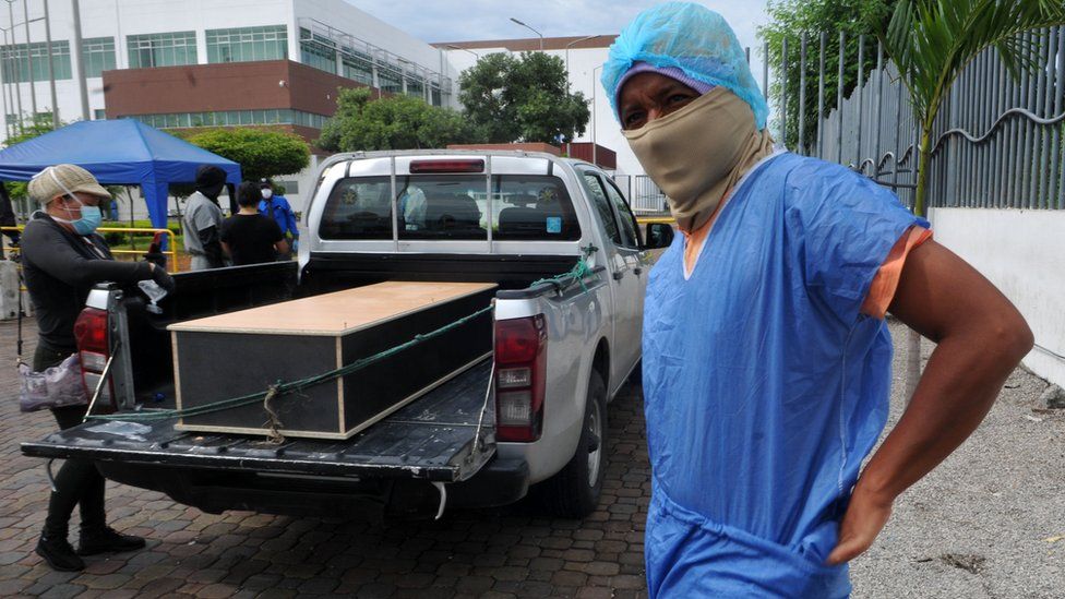 Man in protective kit to identify a relative in a morgue, Guayaquil, 15 Apr 20