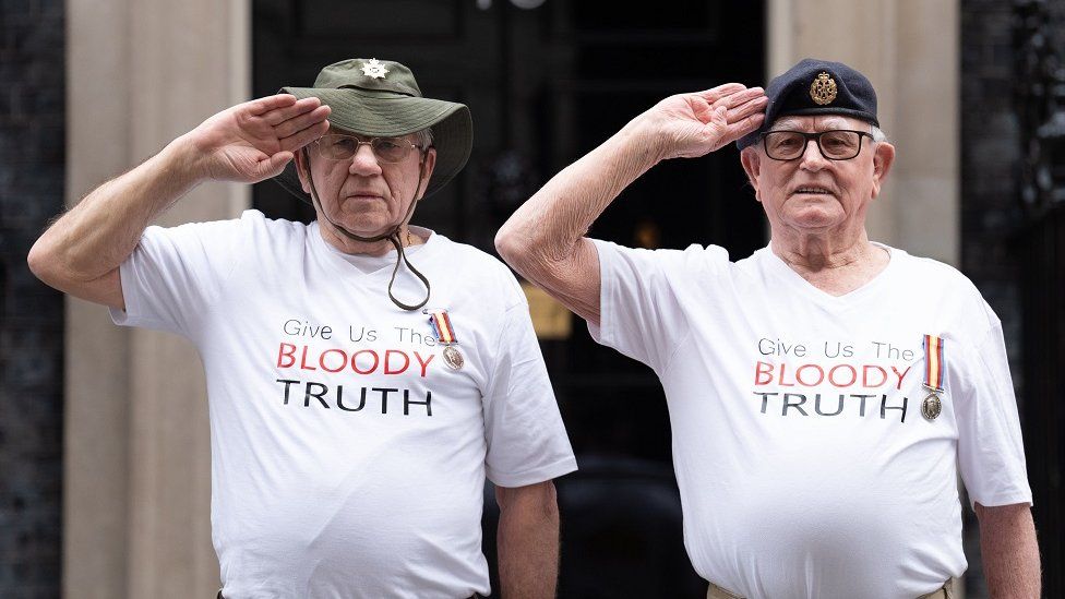 Veterans Terry Quinlan and Brian Unthank salute in front of 10 Downing Street