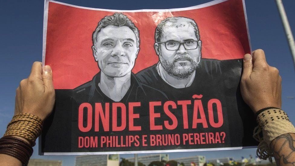 A poster with photos of Dom Phillips and Bruno Pereira