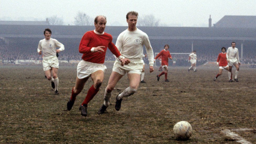 Jack Charlton (right) in action for Leeds challenging his brother, Bobby