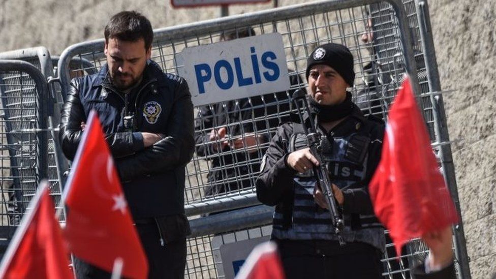 Turkish anti-riot police officers stand guard in front of a police barrier during a demonstration outside the US consulate in Istanbul (30 March 2017)