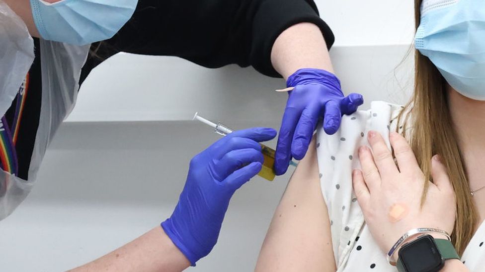 File image showing a close up of a woman's arm as a nurse gives her a Covid vaccine