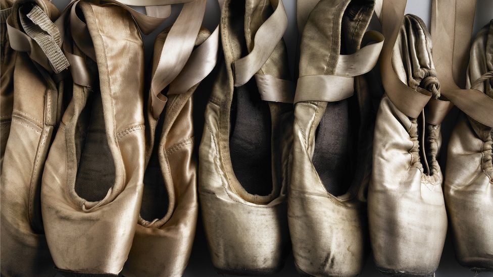 Row of old ballet shoes - stock photo