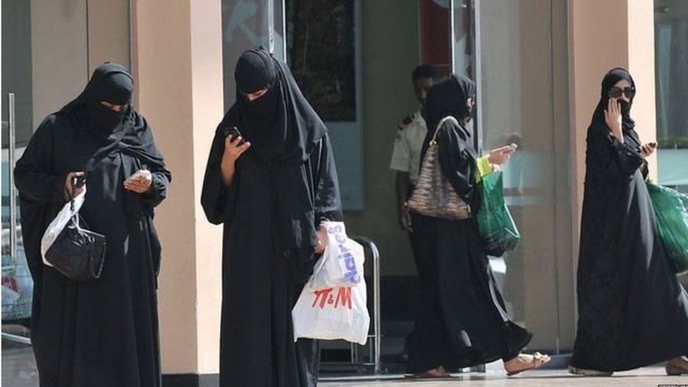 Women wear the abaya on street in Saudi Arabia