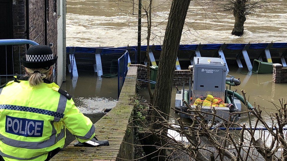 Temporary flood barriers were by the River Severn towards the Wharfage in Ironbridge, Shropshire, during Storm Dennis