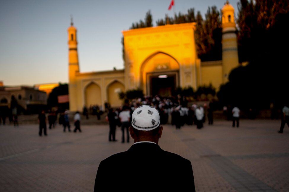 A man arrives for morning prayer in Kashgar, Xinjiang, a mostly Muslim region in north-western China