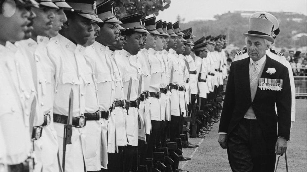 Sir Richard Sharples inspects a guard of honour after arriving to take up his post as governor of Bermuda, October 1972