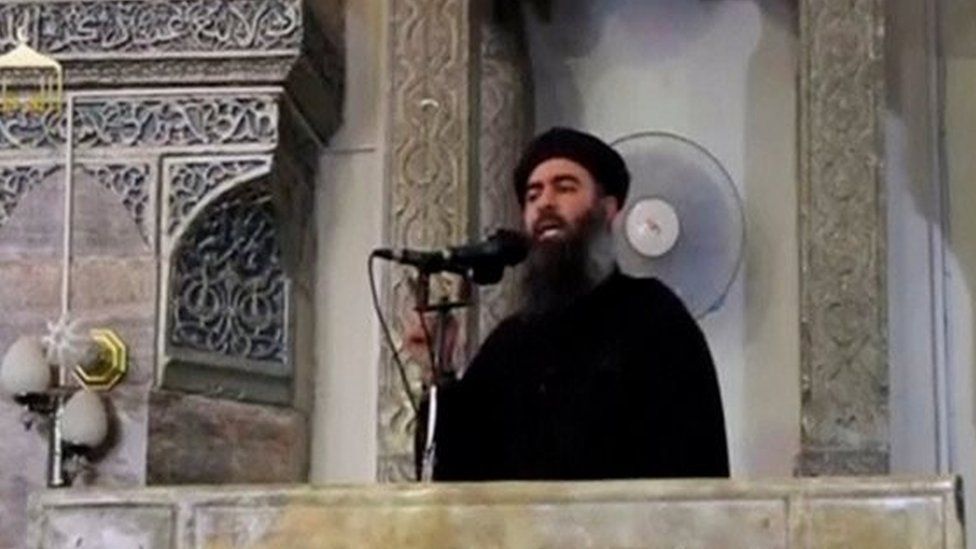 A man purported to be the reclusive leader of the group know as Islamic State, Abu Bakhr al-Baghdadi, speaking a mosque in the centre of Iraq's second city, Mosul (05 July 2014)