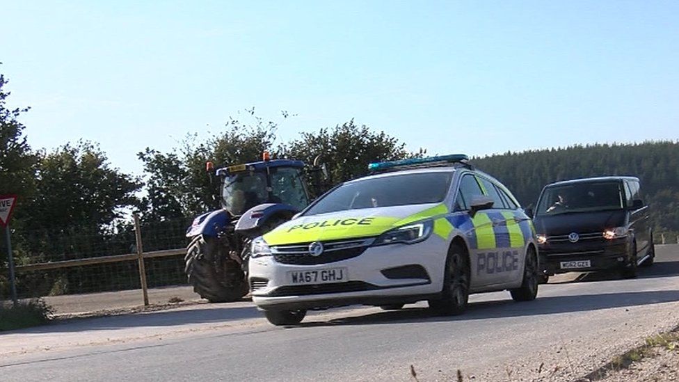 Police cars head towards the mine in Hemerdon