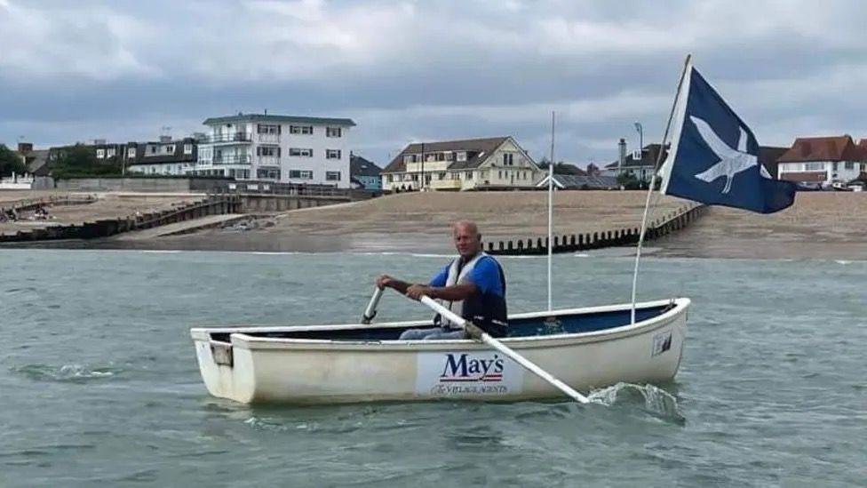 Ross Fisher in a boat.