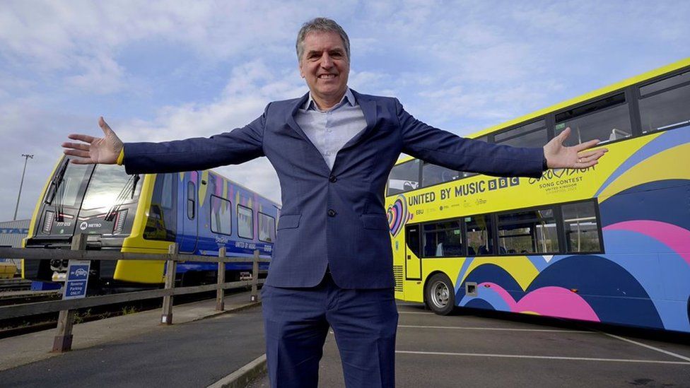 Steve Rotheram in front of the Eurovision buses