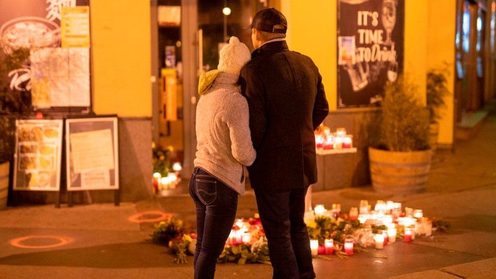 A couple is standing in front of a restaurant the place of the terrorist attack in Vienna, Austria on November 4, 2020