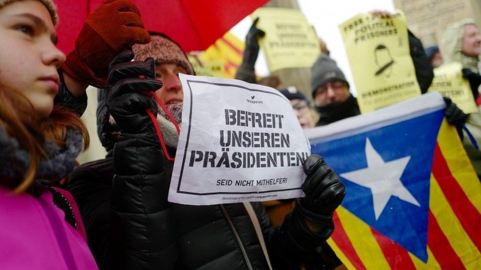 Protesters hold placards banners and flags during a demonstration in support of Catalonian ex-leader Carles Puigdemont in Berlin, Germany, 1 April 2018