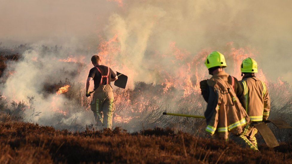 Firefighters tackle a blaze on moorland above Marsden