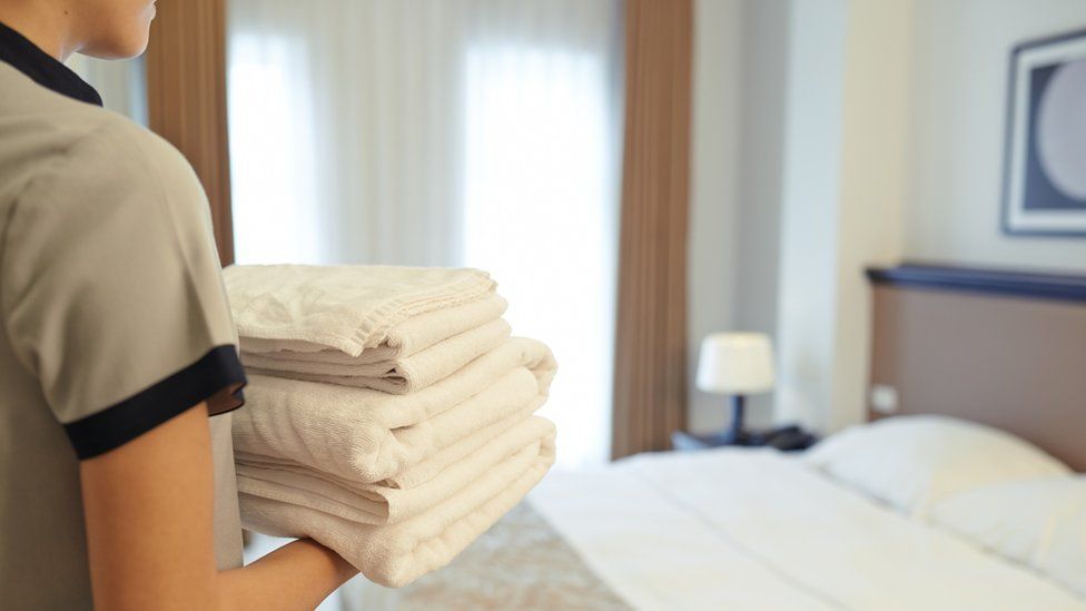 Hotel cleaner replacing towels (stock image)