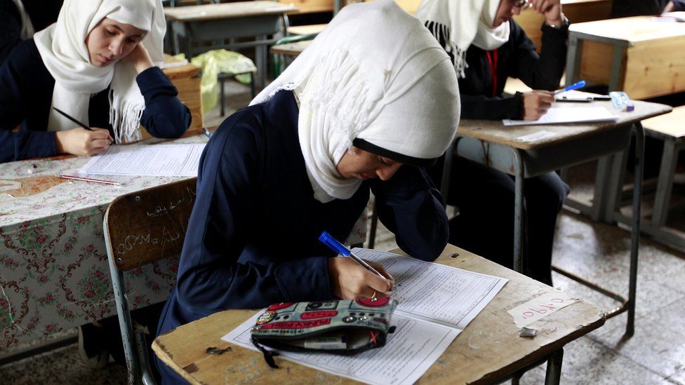 Girls in Yemen classroom take an exam in image taken in 2016