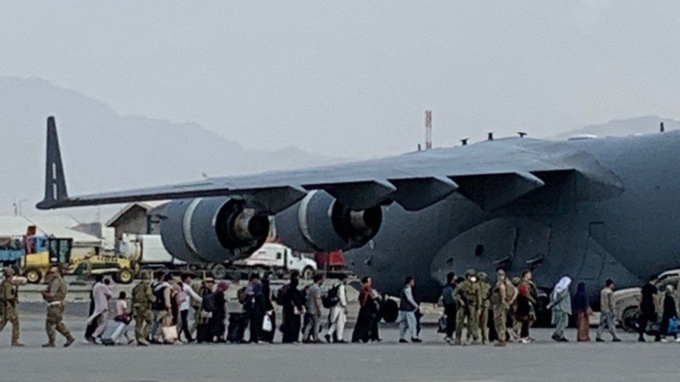 Afghans board a UK C-17 aircraft