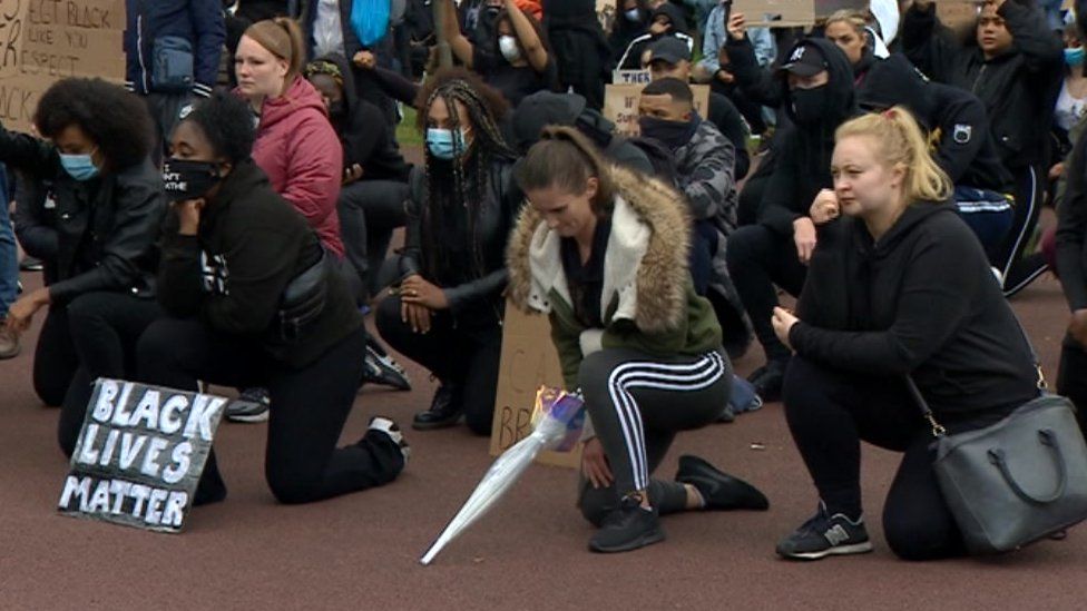 Protesters kneeling